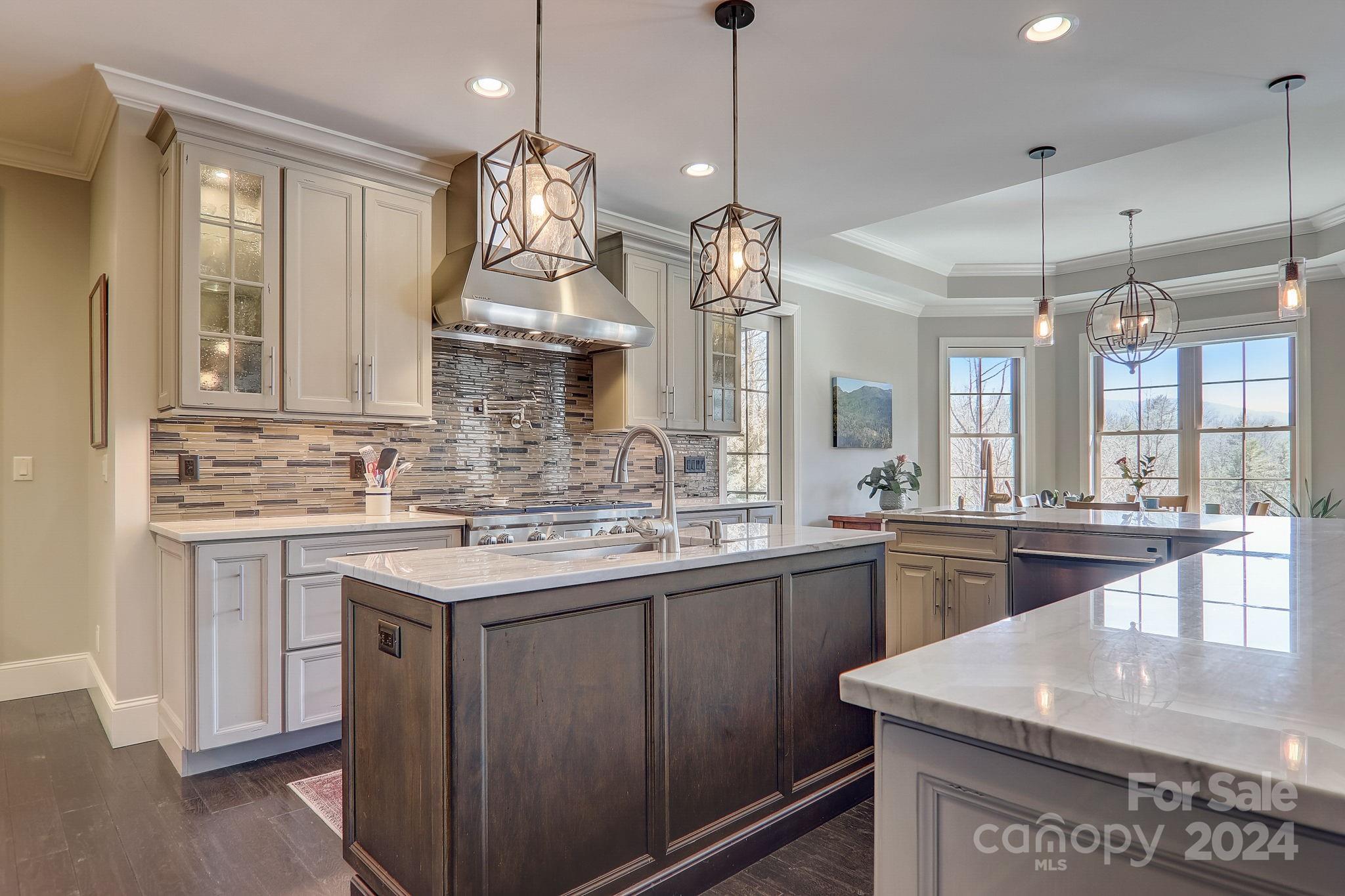 34 Ledgestone Drive Fairview, NC 28730 - Photo 21 of 47 a kitchen with kitchen island granite countertop a sink stove and cabinets