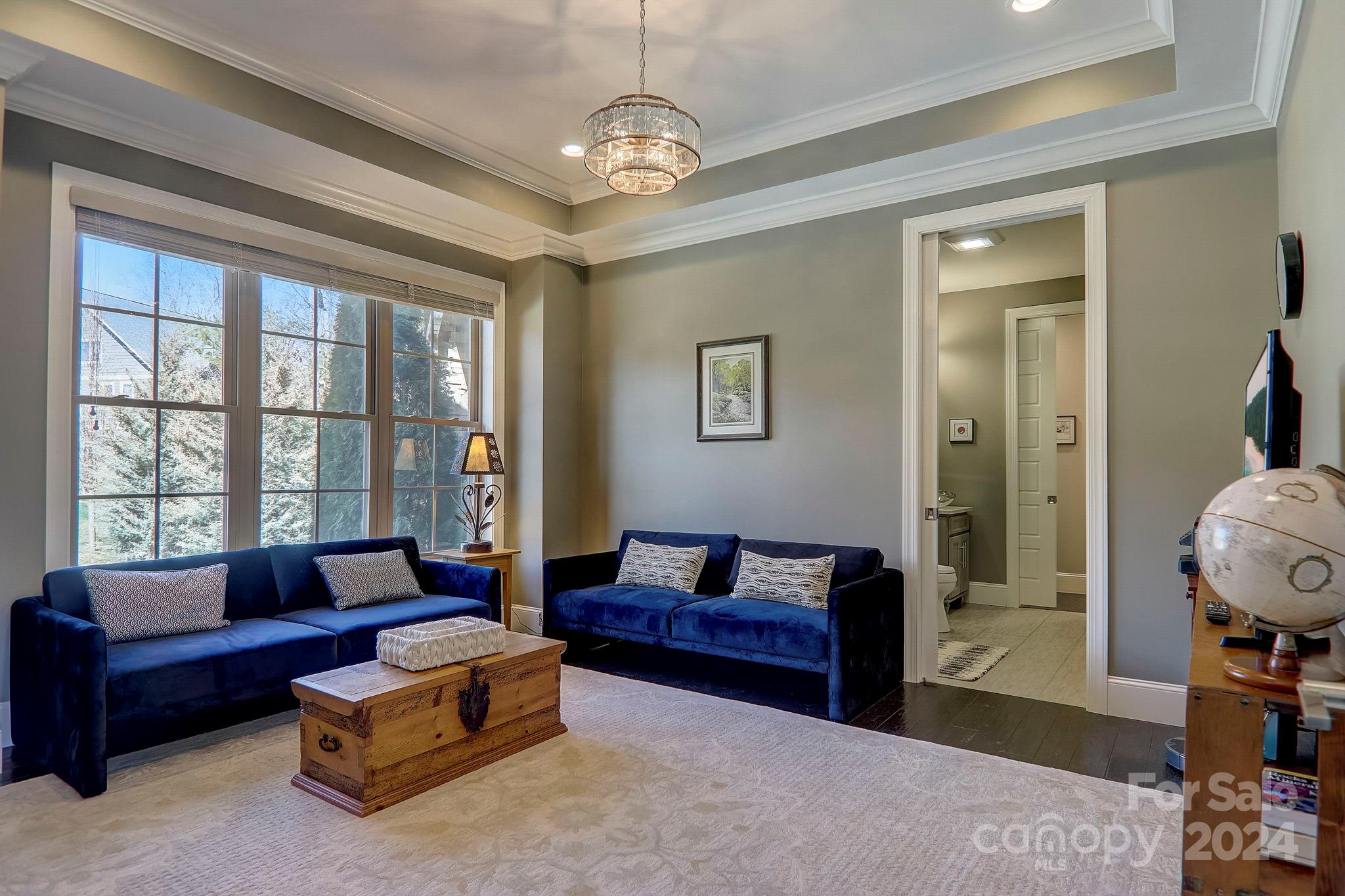 34 Ledgestone Drive Fairview, NC 28730 - Photo 23 of 47 a living room with furniture and a chandelier