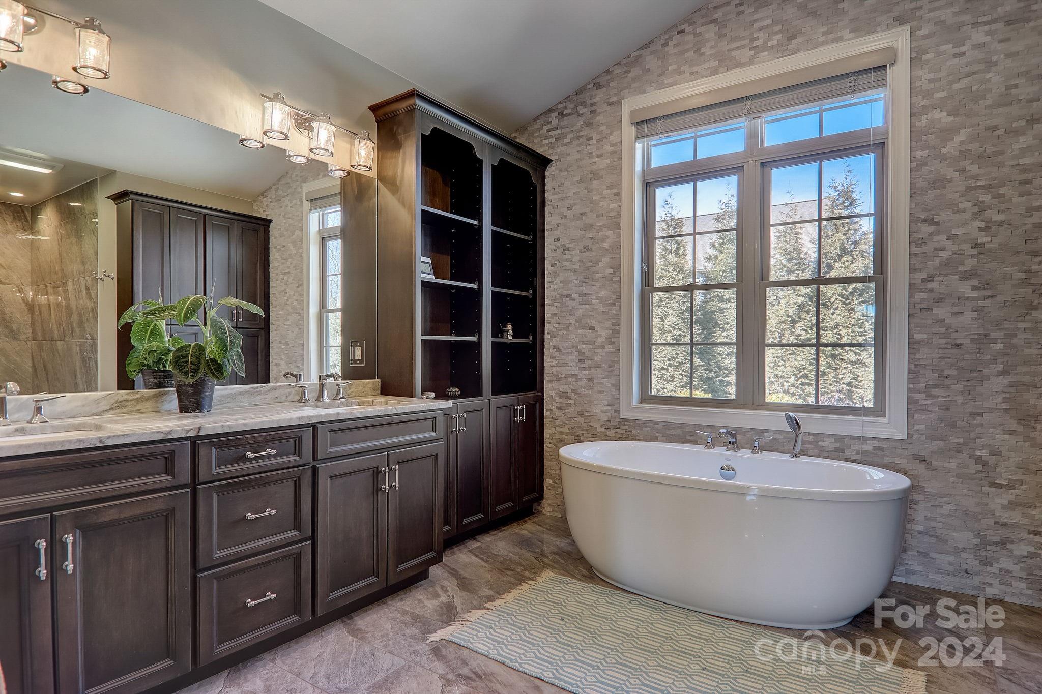 34 Ledgestone Drive Fairview, NC 28730 - Photo 27 of 47 a spacious bathroom with a tub a double vanity sink and large window