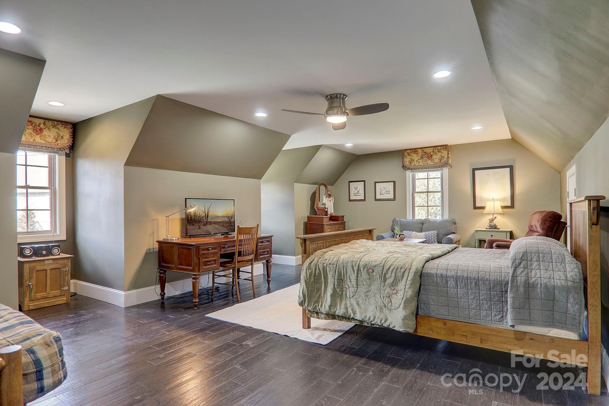 34 Ledgestone Drive Fairview, NC 28730 - Photo 30 of 47 a spacious bedroom with a bed a table and wooden floor
