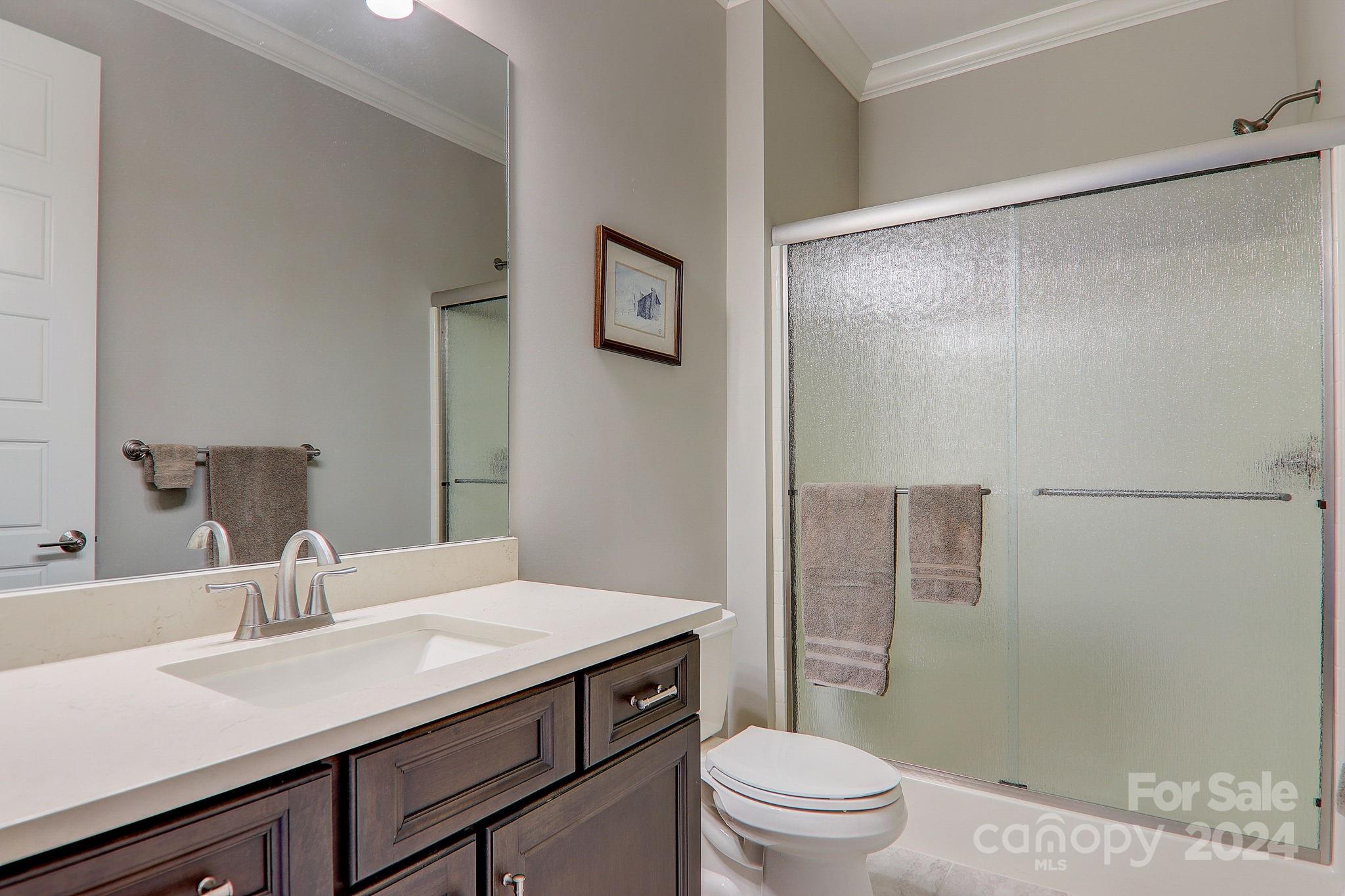 34 Ledgestone Drive Fairview, NC 28730 - Photo 35 of 47 a bathroom with a sink toilet a mirror and shower