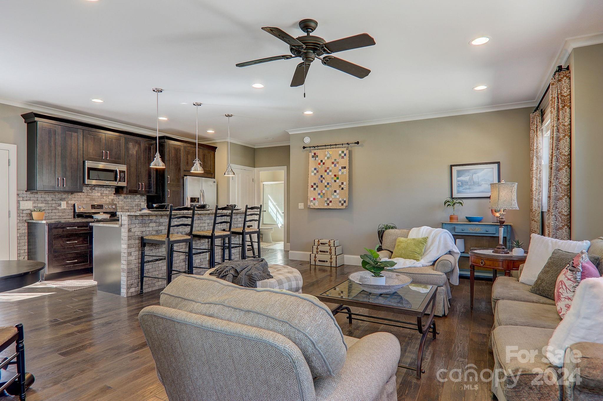 34 Ledgestone Drive Fairview, NC 28730 - Photo 41 of 47 a living room with furniture kitchen view and a wooden floor