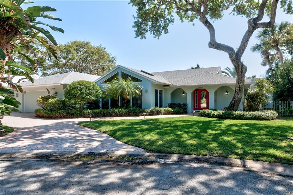 a view of a house with a yard and tree s