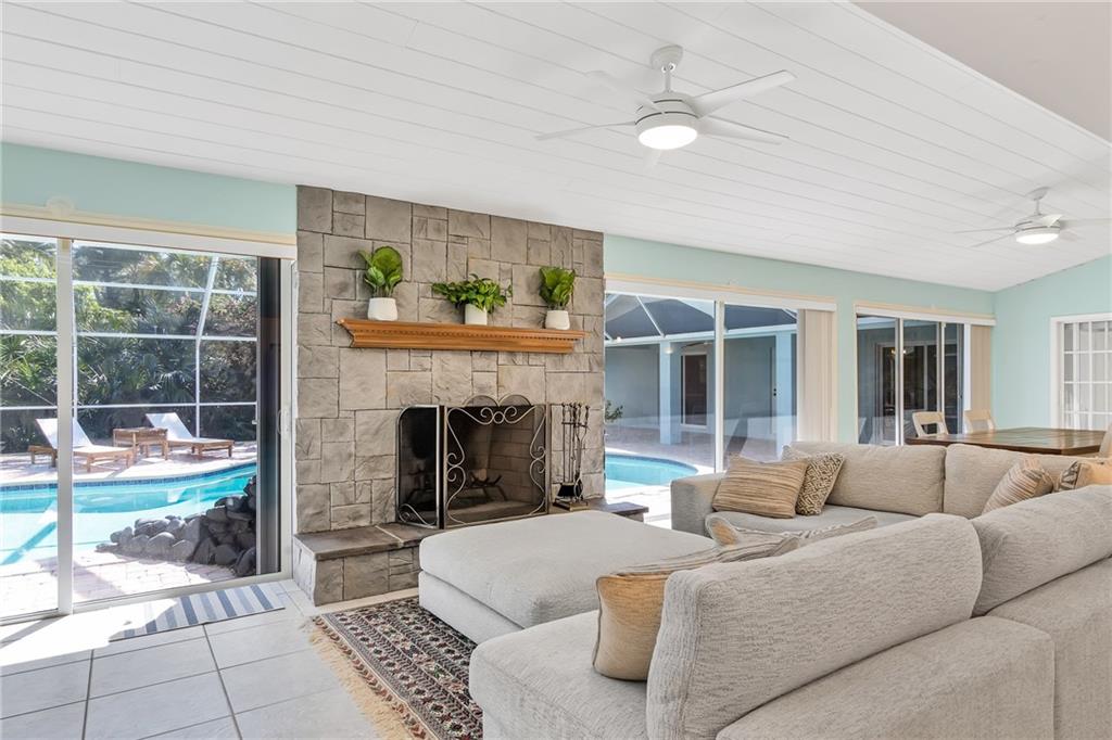 2075 Spring Place Vero Beach, FL 32963 - Photo 11 of 36 a living room with furniture and a fireplace