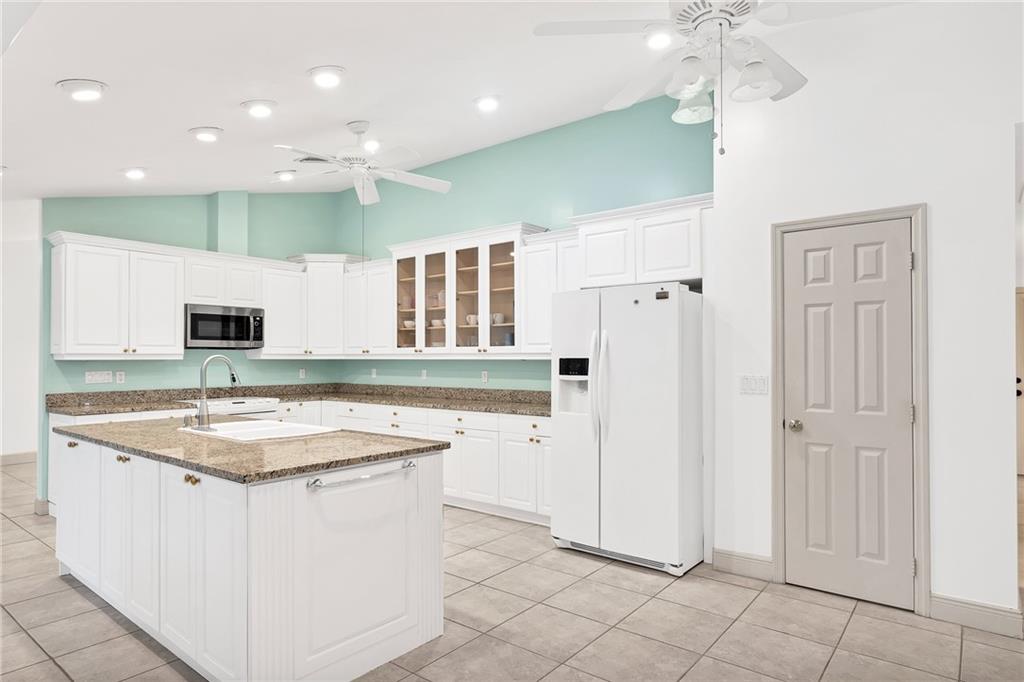 2075 Spring Place Vero Beach, FL 32963 - Photo 13 of 36 a kitchen with a stove a refrigerator and a sink