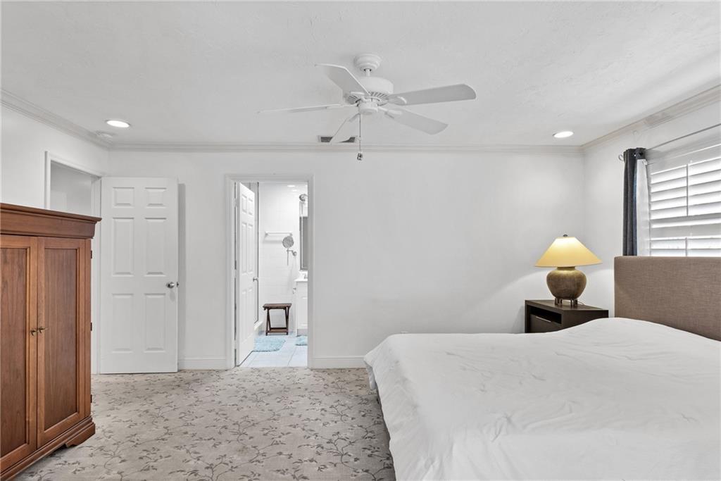 2075 Spring Place Vero Beach, FL 32963 - Photo 19 of 36 a bedroom with a bed and a chandelier
