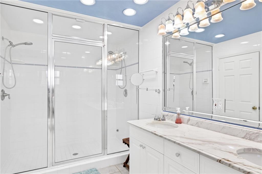 2075 Spring Place Vero Beach, FL 32963 - Photo 21 of 36 a bathroom with a granite countertop sink a mirror and shower