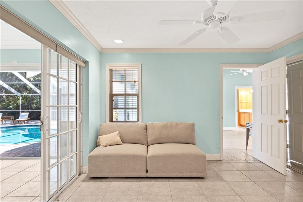 2075 Spring Place Vero Beach, FL 32963 - Photo 24 of 36 a living room with furniture and a floor to ceiling window