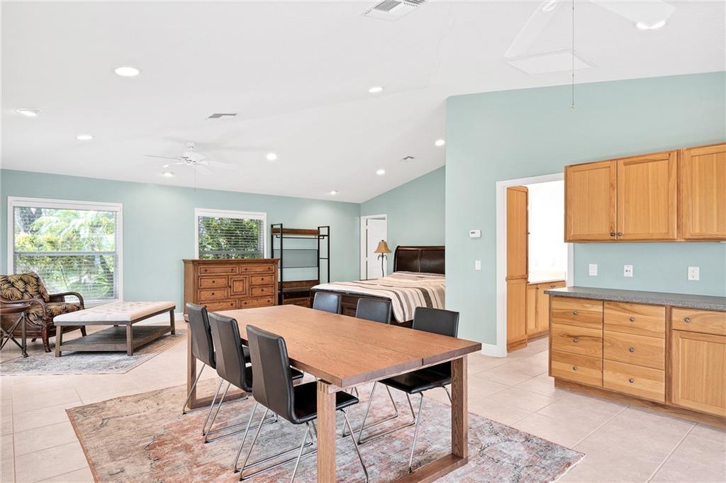 2075 Spring Place Vero Beach, FL 32963 - Photo 26 of 36 a living room with stainless steel appliances furniture a rug and a kitchen view