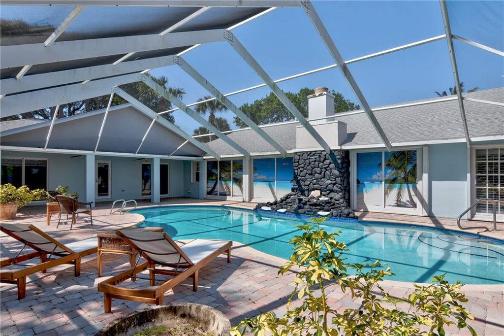 2075 Spring Place Vero Beach, FL 32963 - Photo 31 of 36 a view of a patio with table and chairs under an umbrella
