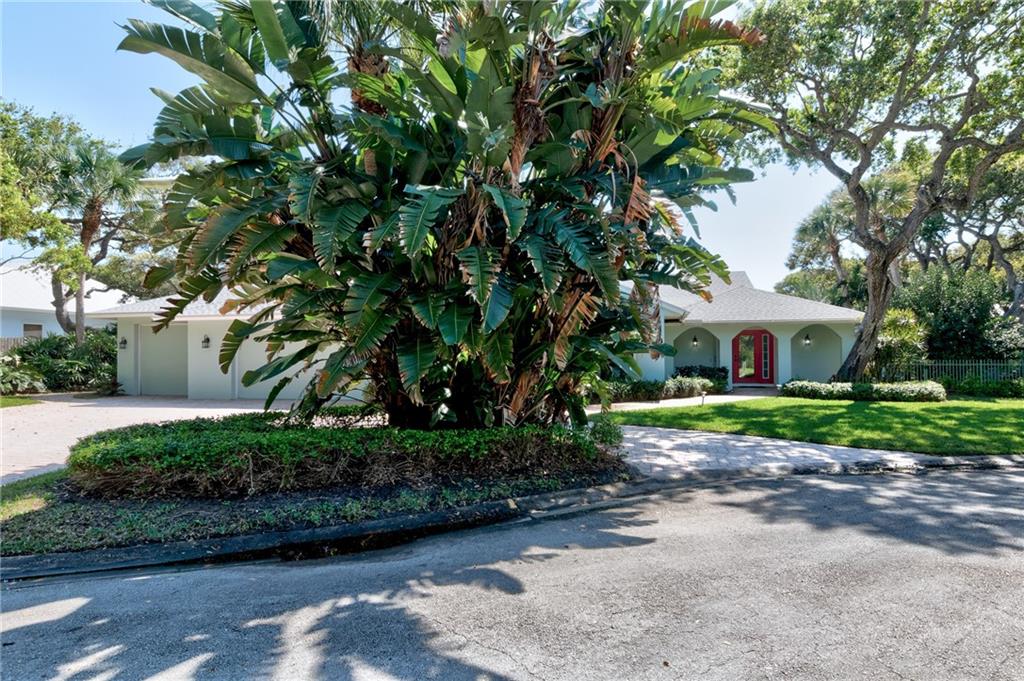2075 Spring Place Vero Beach, FL 32963 - Photo 5 of 36 a front view of a house with a garden