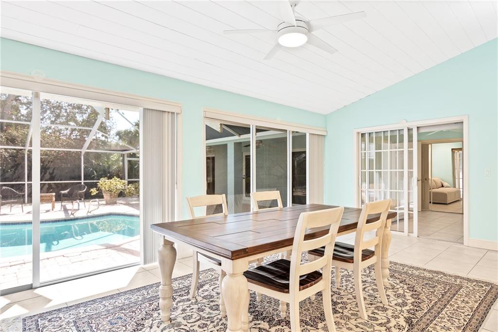 2075 Spring Place Vero Beach, FL 32963 - Photo 10 of 36 a view of a dining room with furniture wooden floor and a rug