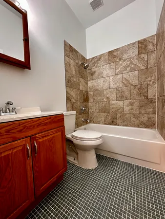 a kitchen with stainless steel appliances a stove a microwave and a hard wood floor