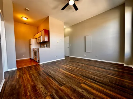 a view of a kitchen with wooden floor and electronic appliances