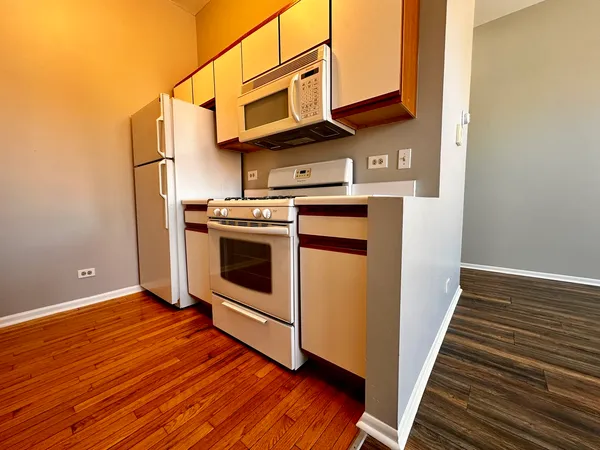 a view of walk in closet with wooden floor