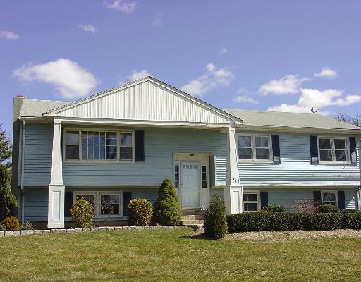 a front view of a house with a yard and a garage