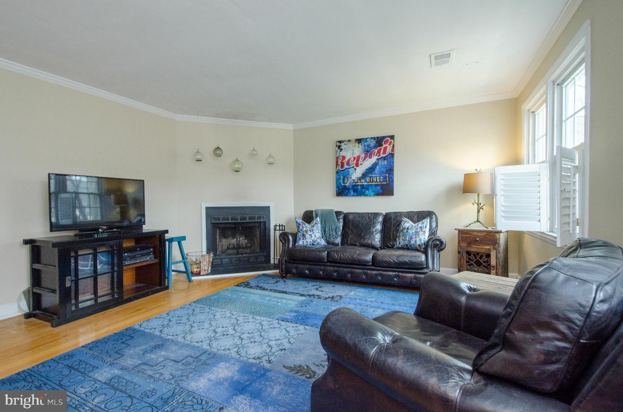 2912 13th Road South, Unit 204 Arlington, VA 22204 - Photo 3 of 13 a living room with furniture a flat screen tv and a fireplace