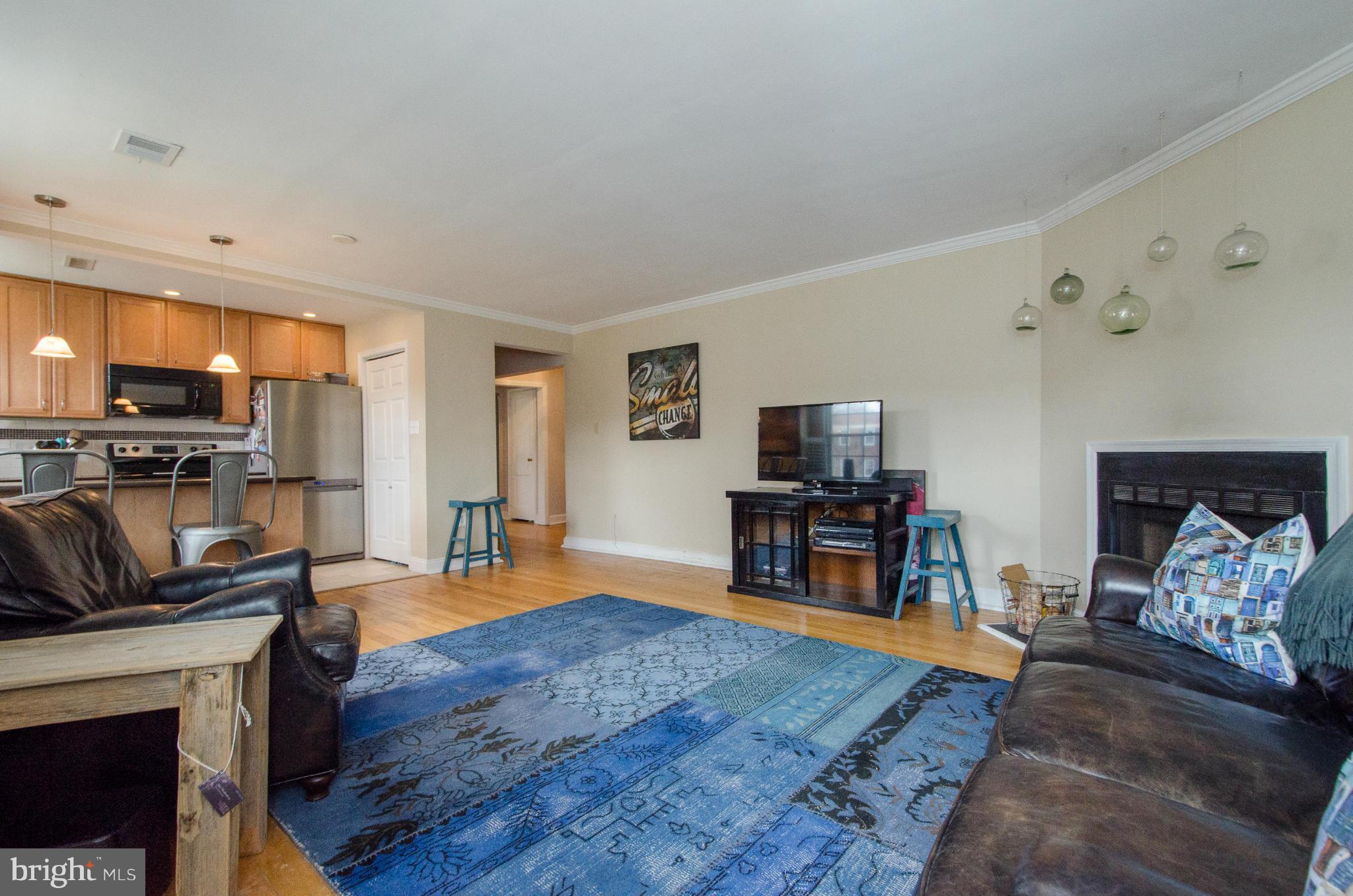 2912 13th Road South, Unit 204 Arlington, VA 22204 - Photo 4 of 13 a living room with fireplace furniture and a flat screen tv
