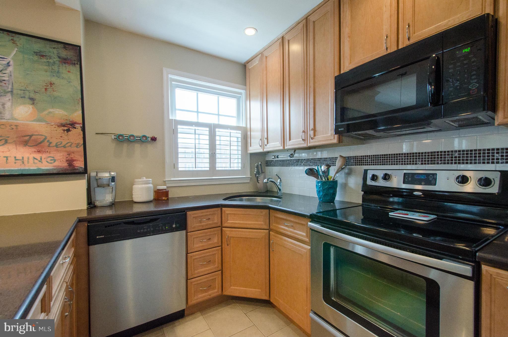 2912 13th Road South, Unit 204 Arlington, VA 22204 - Photo 8 of 13 a kitchen with stainless steel appliances a stove sink and microwave