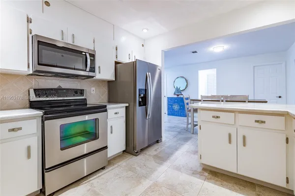 a kitchen with a refrigerator stove and microwave