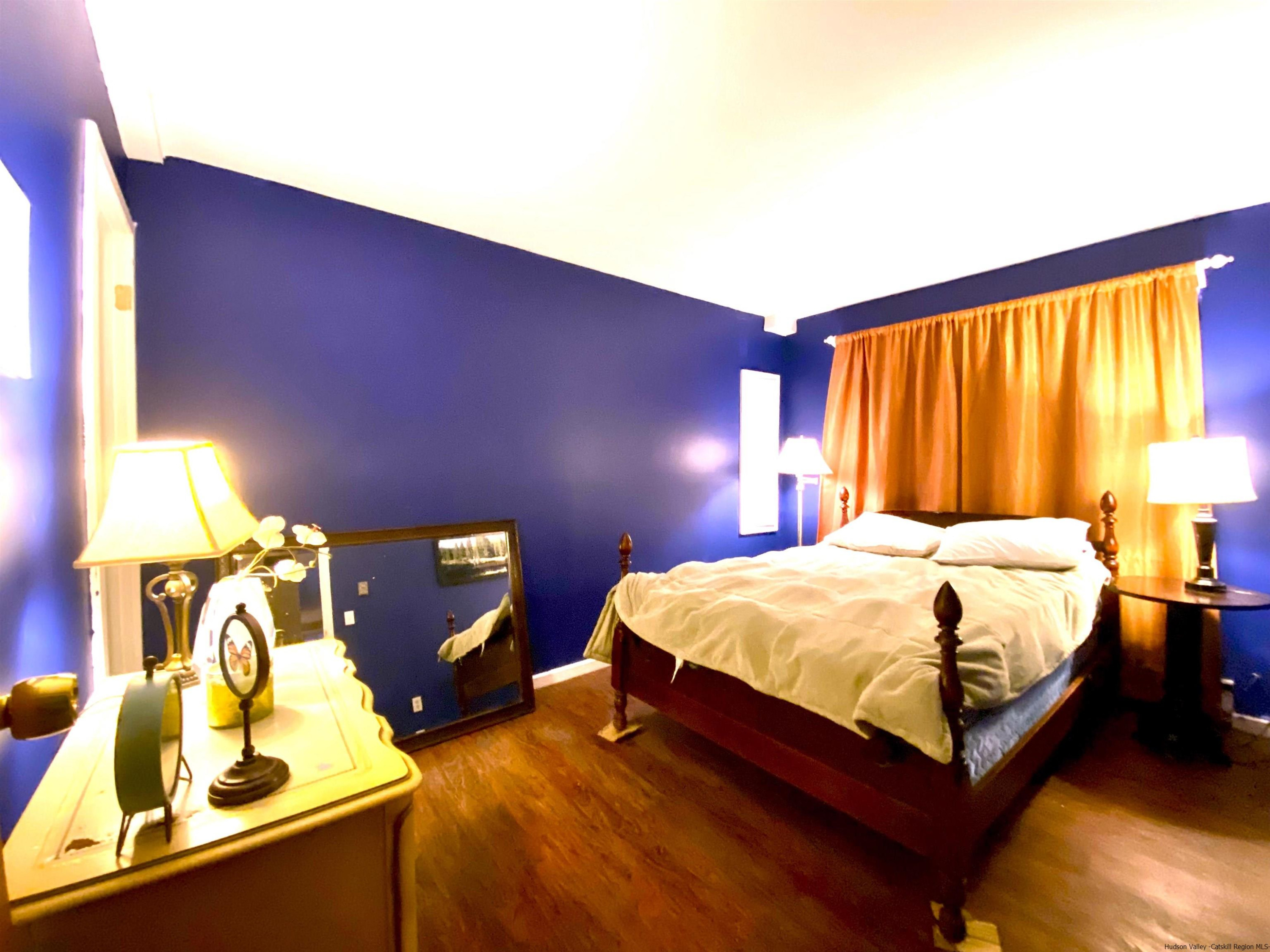 295 Grog Kill Road Willow, NY 12495 - Photo 7 of 14 a bed sitting in a bedroom next to a window