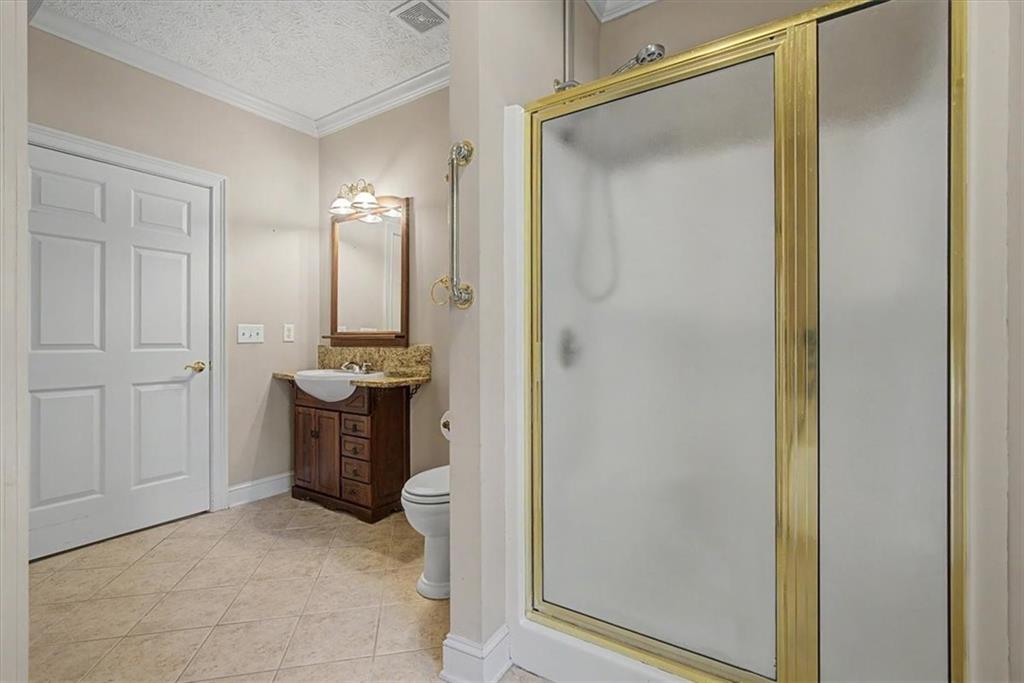 1136 Cole Lake Road Dallas, GA 30157 - Photo 35 of 72 a bathroom with a granite countertop sink mirror and shower