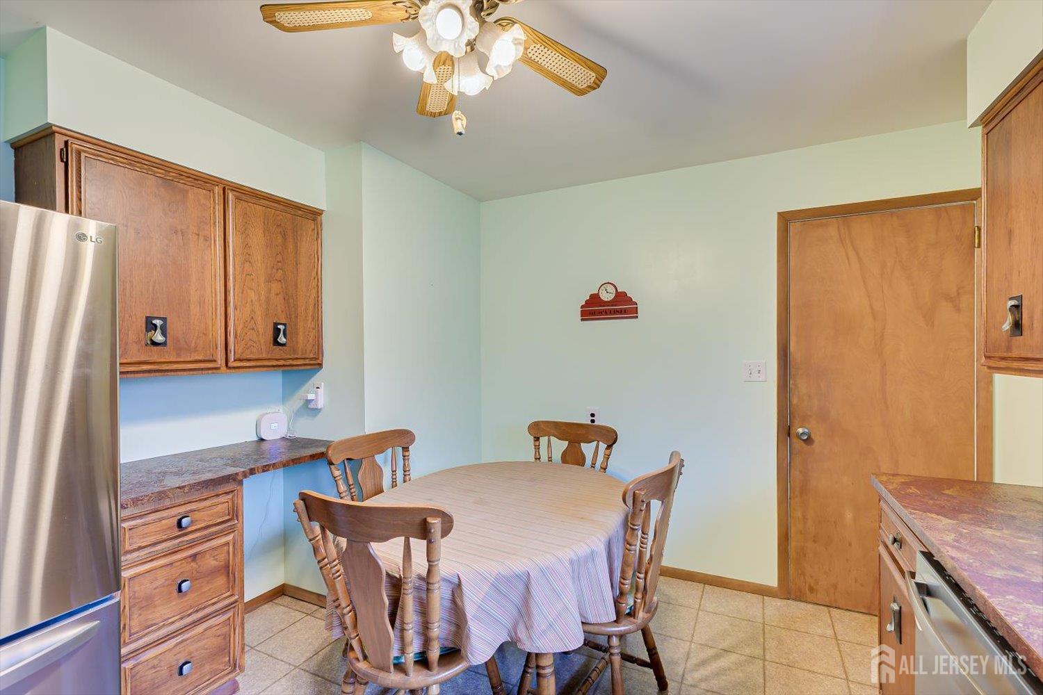 65 Rose Street Edison, NJ 08817 - Photo 14 of 35 a dining room with stainless steel appliances a table and chairs