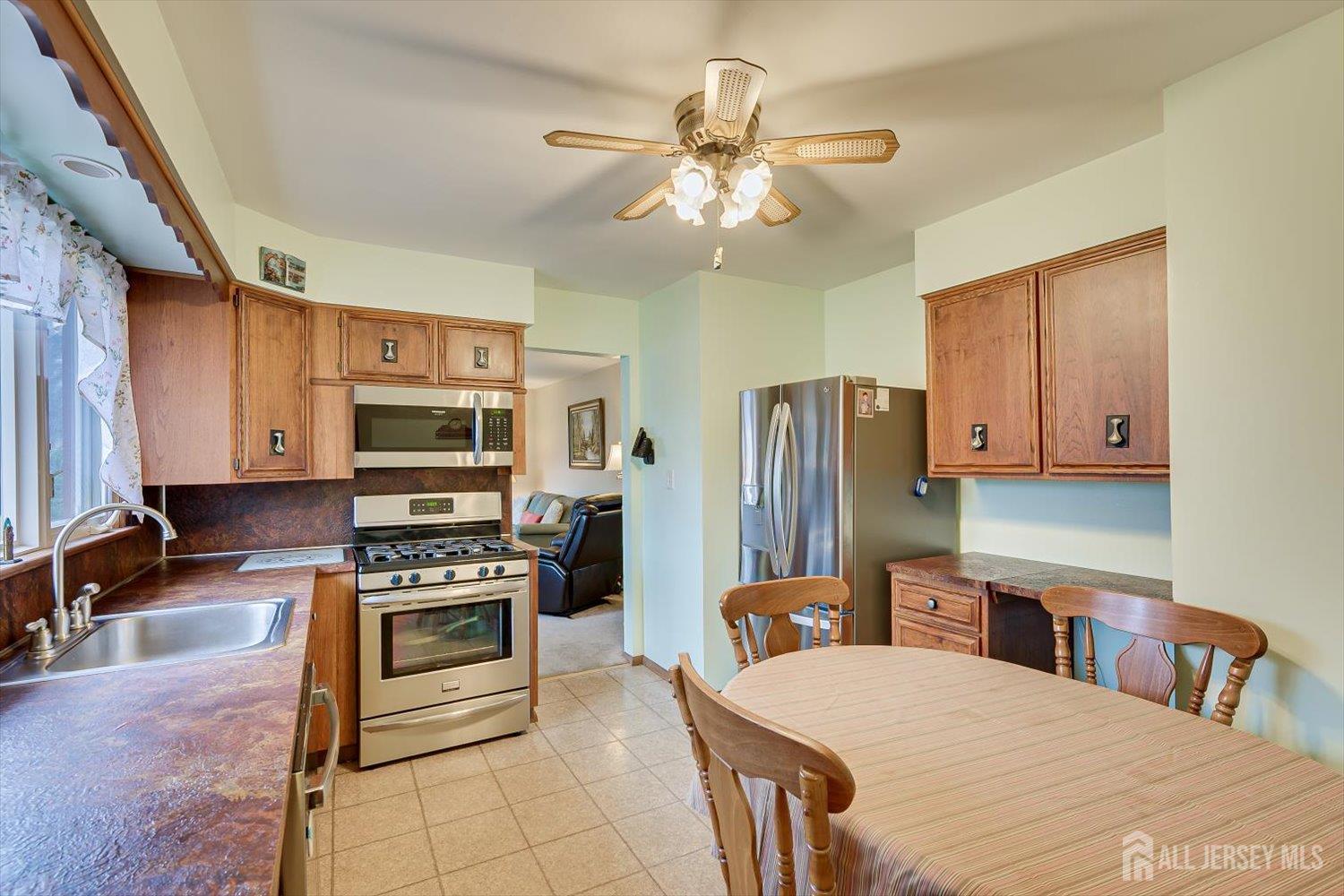 65 Rose Street Edison, NJ 08817 - Photo 15 of 35 a kitchen with stainless steel appliances a stove refrigerator sink and microwave