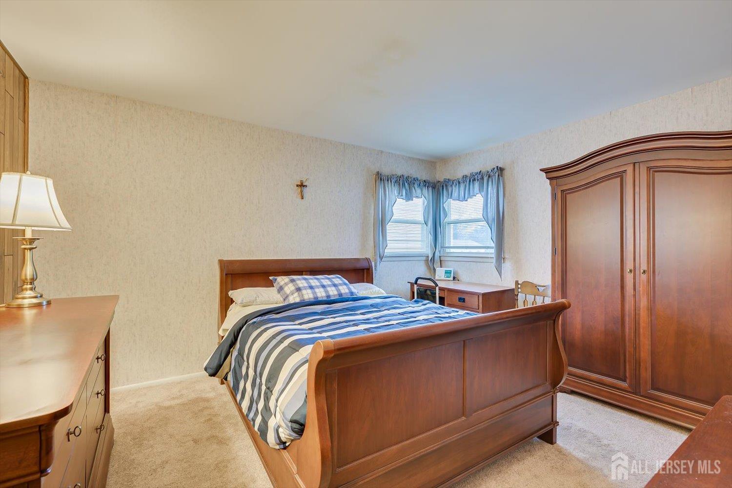 65 Rose Street Edison, NJ 08817 - Photo 16 of 35 a bed sitting in a bedroom next to a window