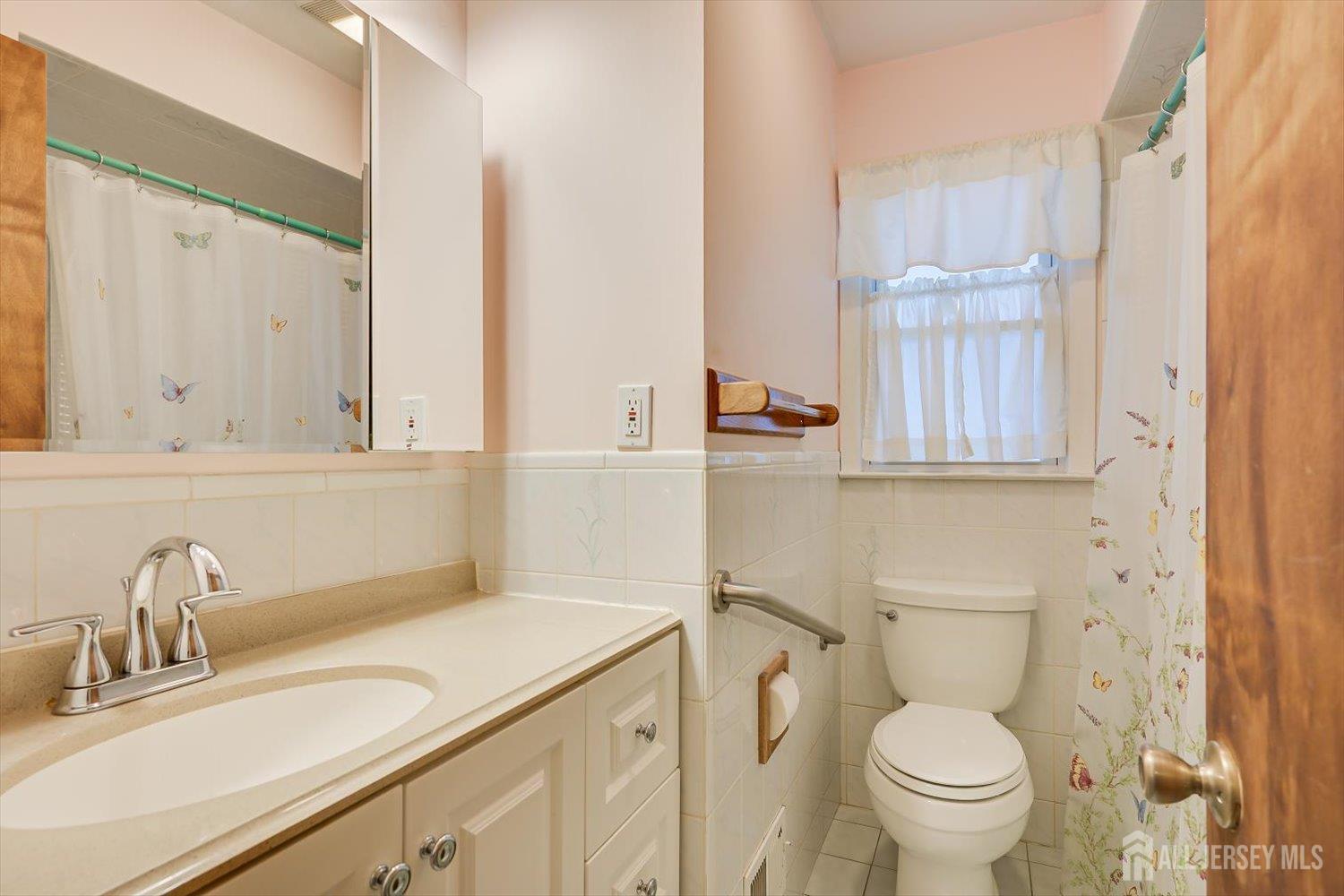 65 Rose Street Edison, NJ 08817 - Photo 19 of 35 a bathroom with a sink toilet vanity and mirror