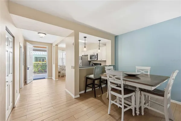 a view of a dining room with furniture and wooden floor