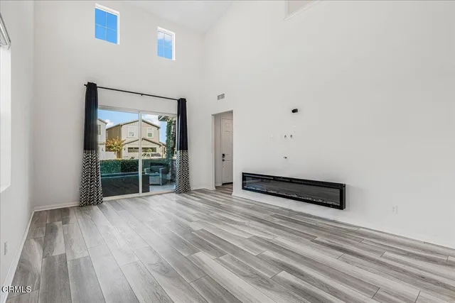 a spacious bathroom with a double vanity sink a mirror and a shower