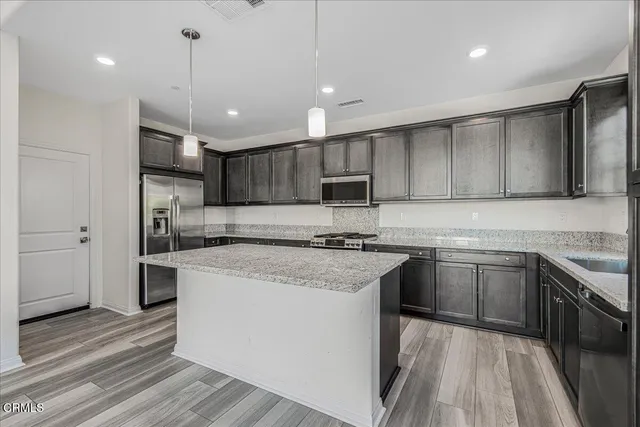a white toilet sitting next to a white wall