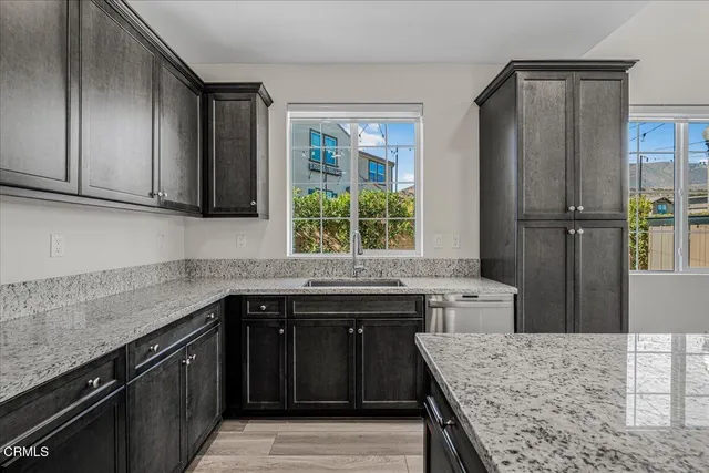 a view of a lake with lawn chairs and a table and chairs