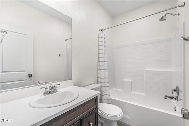 a view of a room with lots of wooden furniture and a large window