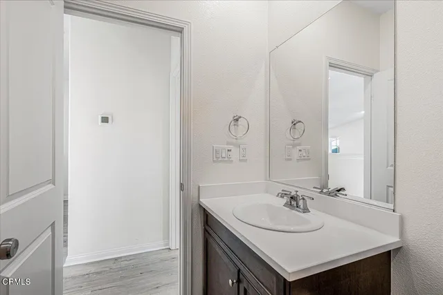 a view of a room with lots of furniture and wooden floor