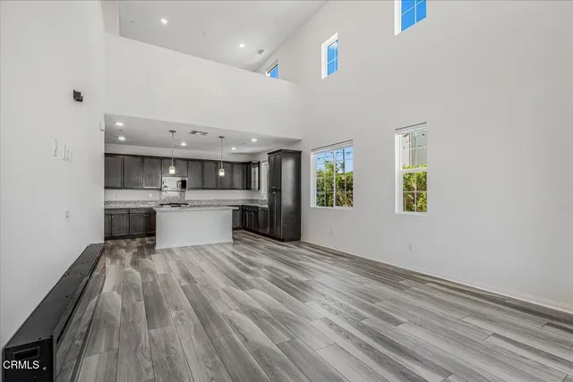 a view of a room with wooden floor and white walls