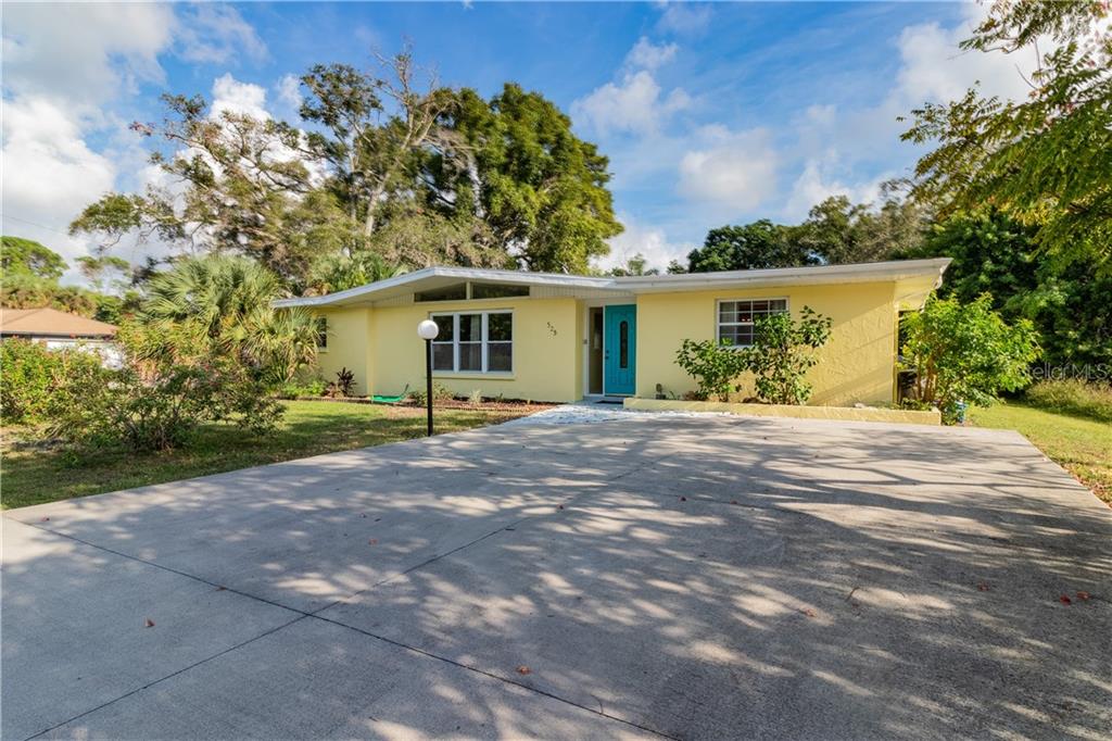 325 Terrapin Road Venice, FL 34293 - Photo 1 of 1 a front view of a house with a yard and a garden