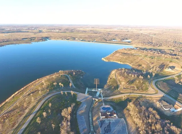 an aerial view of a house with backyard