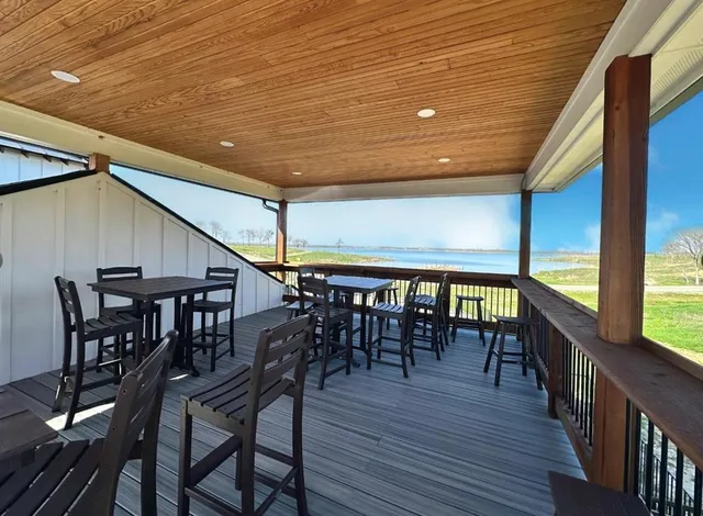 an outdoor space with furniture and wooden floor