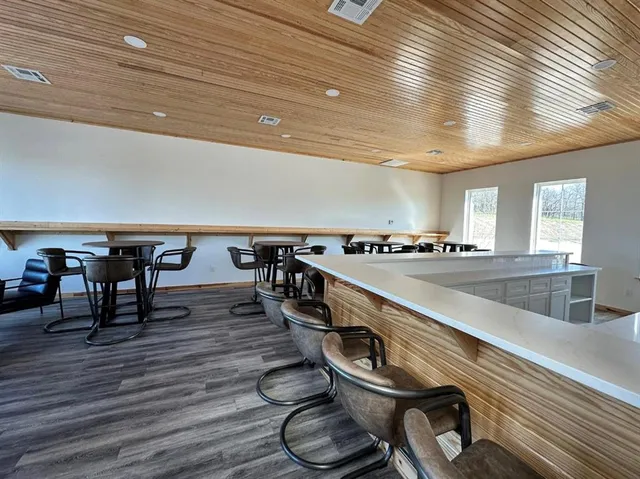 a room with gym equipment and wooden floor
