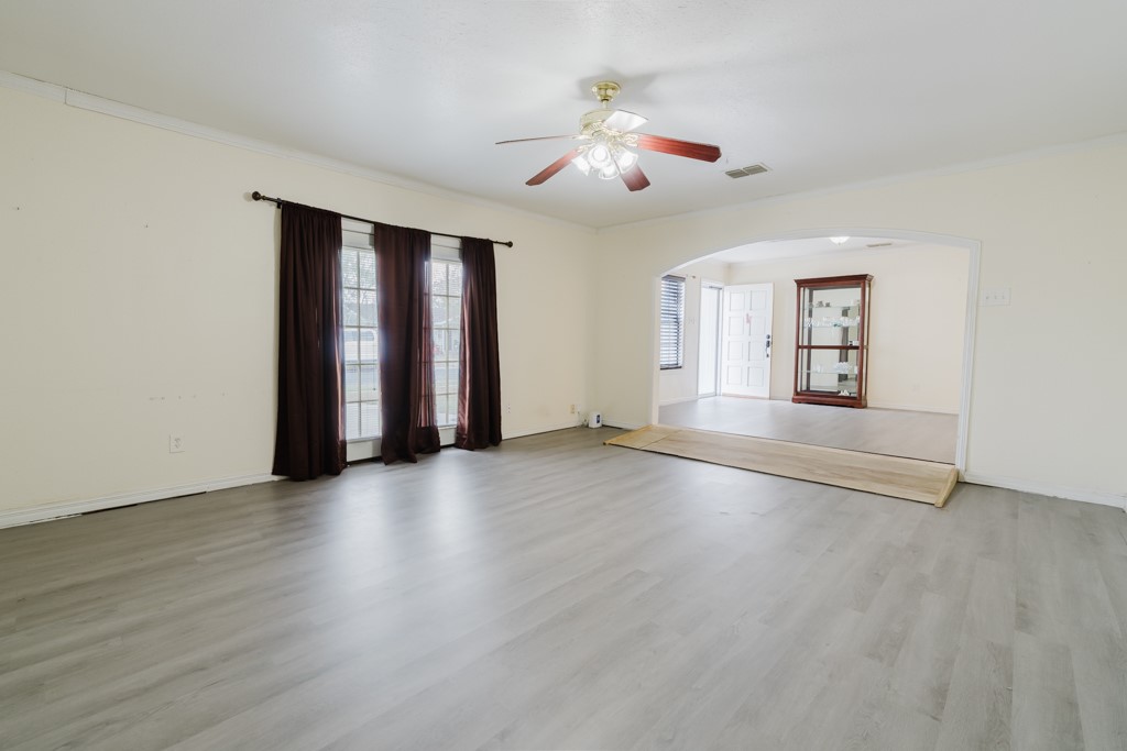 1401 Barcelona Drive Corpus Christi, TX 78416 - Photo 5 of 13 an empty room with wooden floor and windows