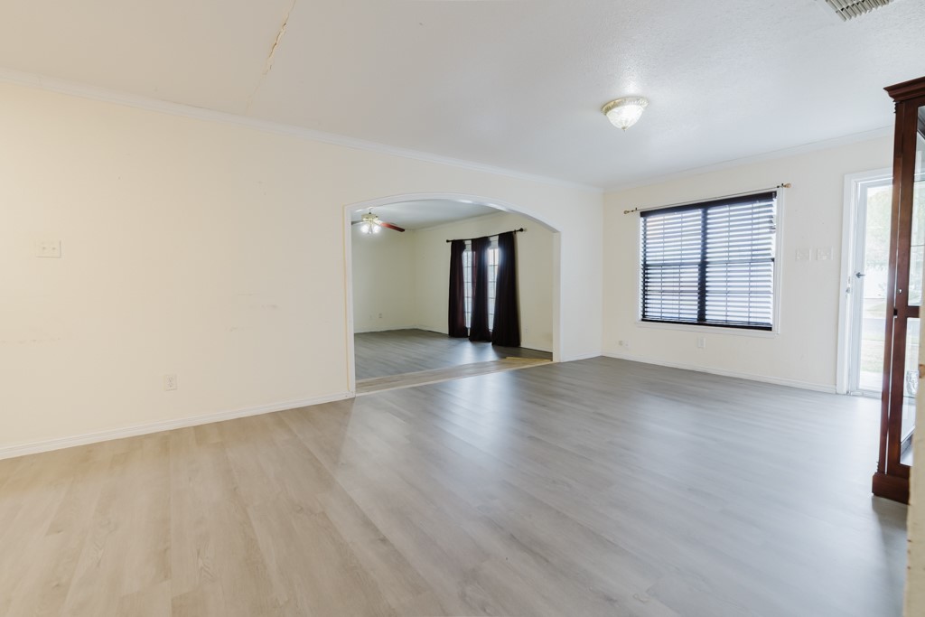 1401 Barcelona Drive Corpus Christi, TX 78416 - Photo 6 of 13 an empty room with wooden floor and windows