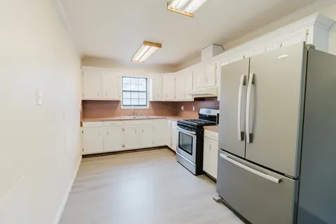 a kitchen with stainless steel appliances a refrigerator sink and microwave
