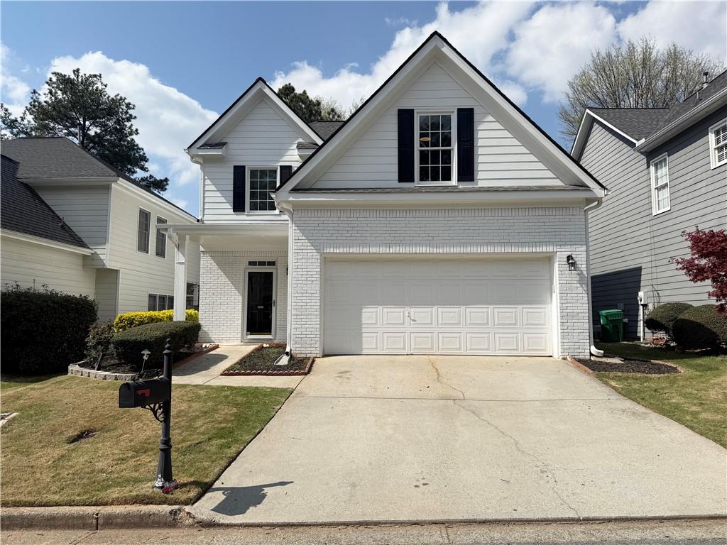 2936 Winter Rose Court Dunwoody, GA 30360 - Photo 1 of 1 a front view of a house with garden
