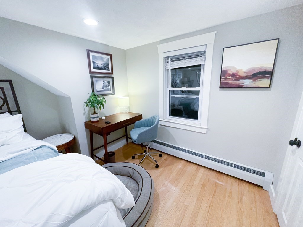 83 Rockridge Road Waltham, MA 02453 - Photo 16 of 16 a bedroom with a bed and paintings on the wall