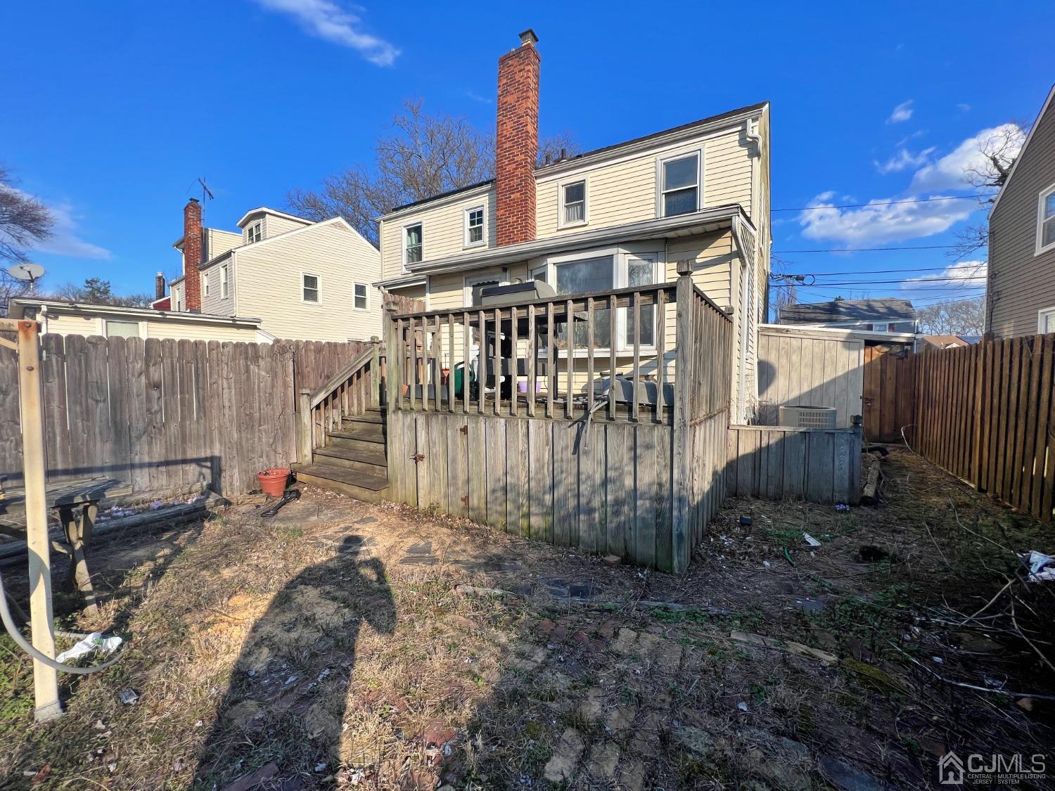 118 MacArthur Drive Edison, NJ 08837 - Photo 14 of 16 a view of a house with a wooden fence