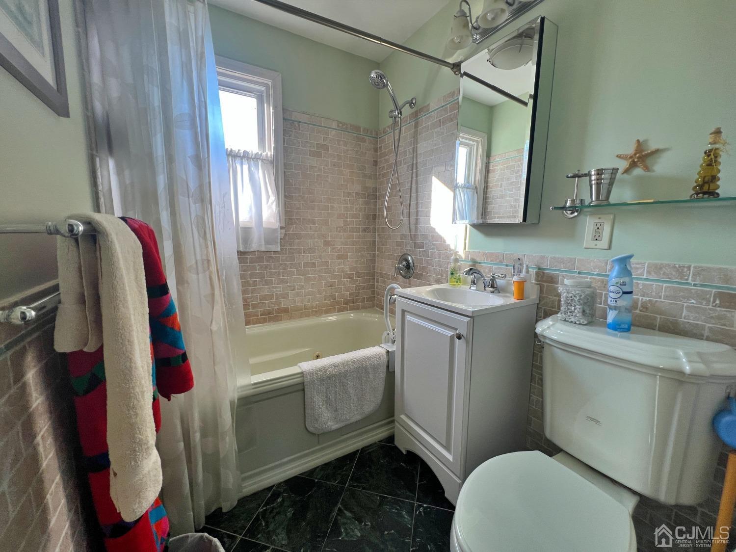 118 MacArthur Drive Edison, NJ 08837 - Photo 9 of 16 a bathroom with a sink toilet and shower