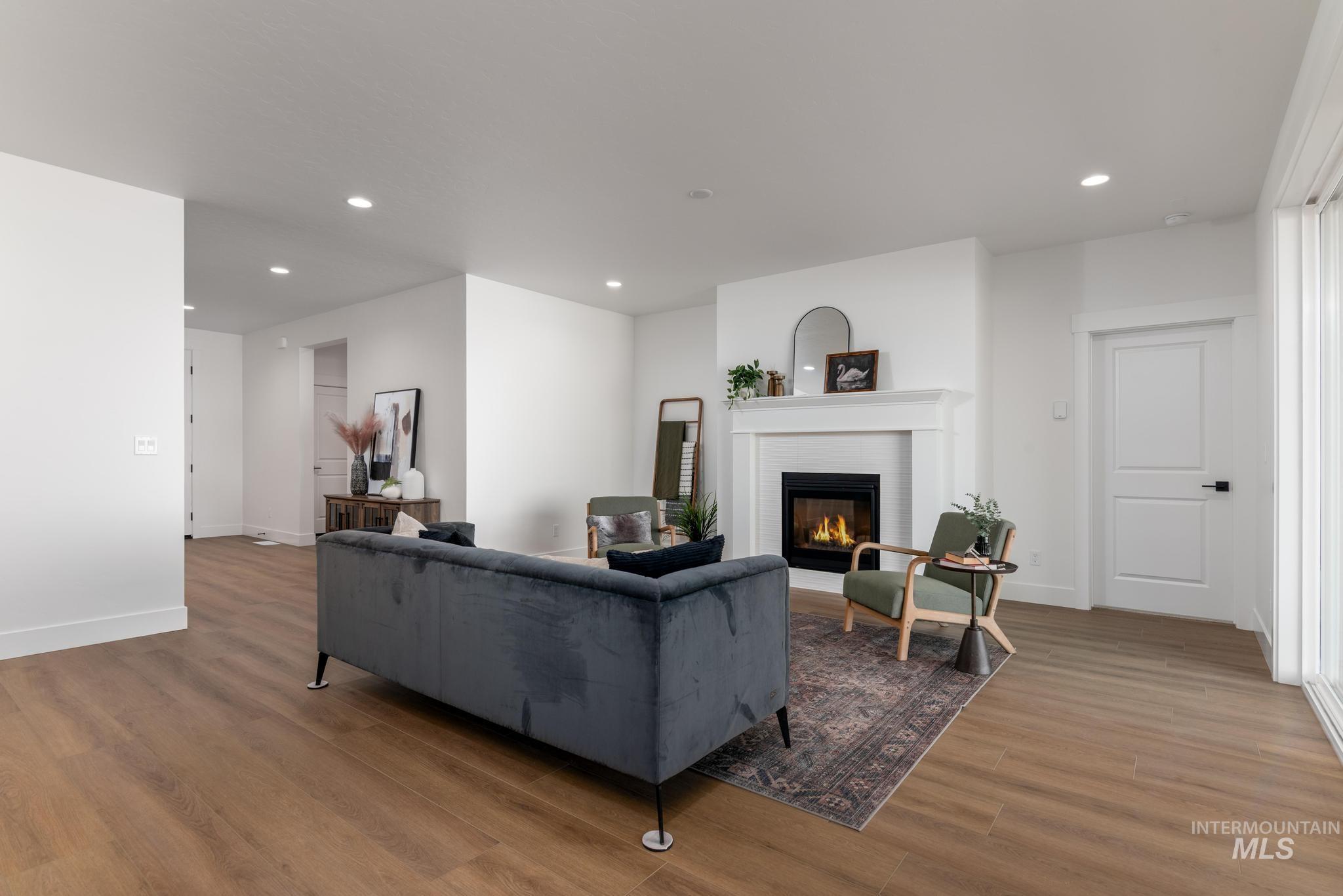 1925 Buckbrush Avenue Middleton, ID 83644 - Photo 2 of 20 Living area featuring a classic fireplace with a white mantel, recessed lighting, and wood-finish flooring
