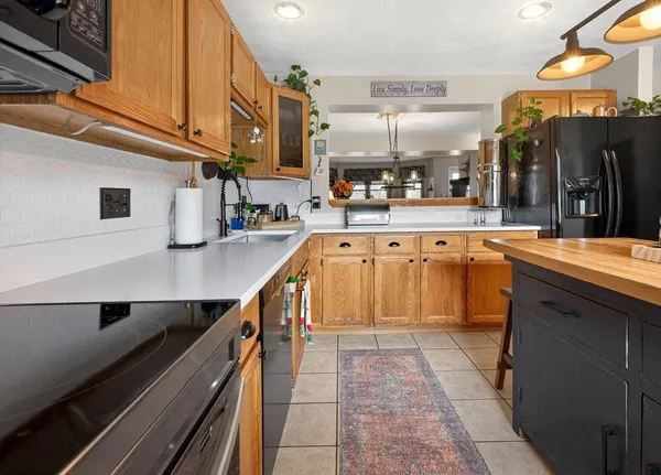 a kitchen with stainless steel appliances granite countertop a sink and cabinets